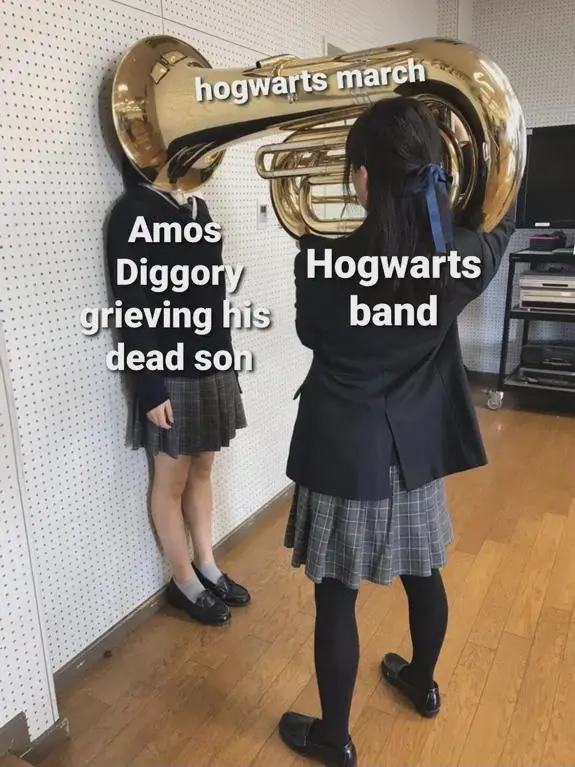 Two students in school uniforms stand beside a large golden tuba. The tuba is labeled 'hogwarts march'. The student on the…