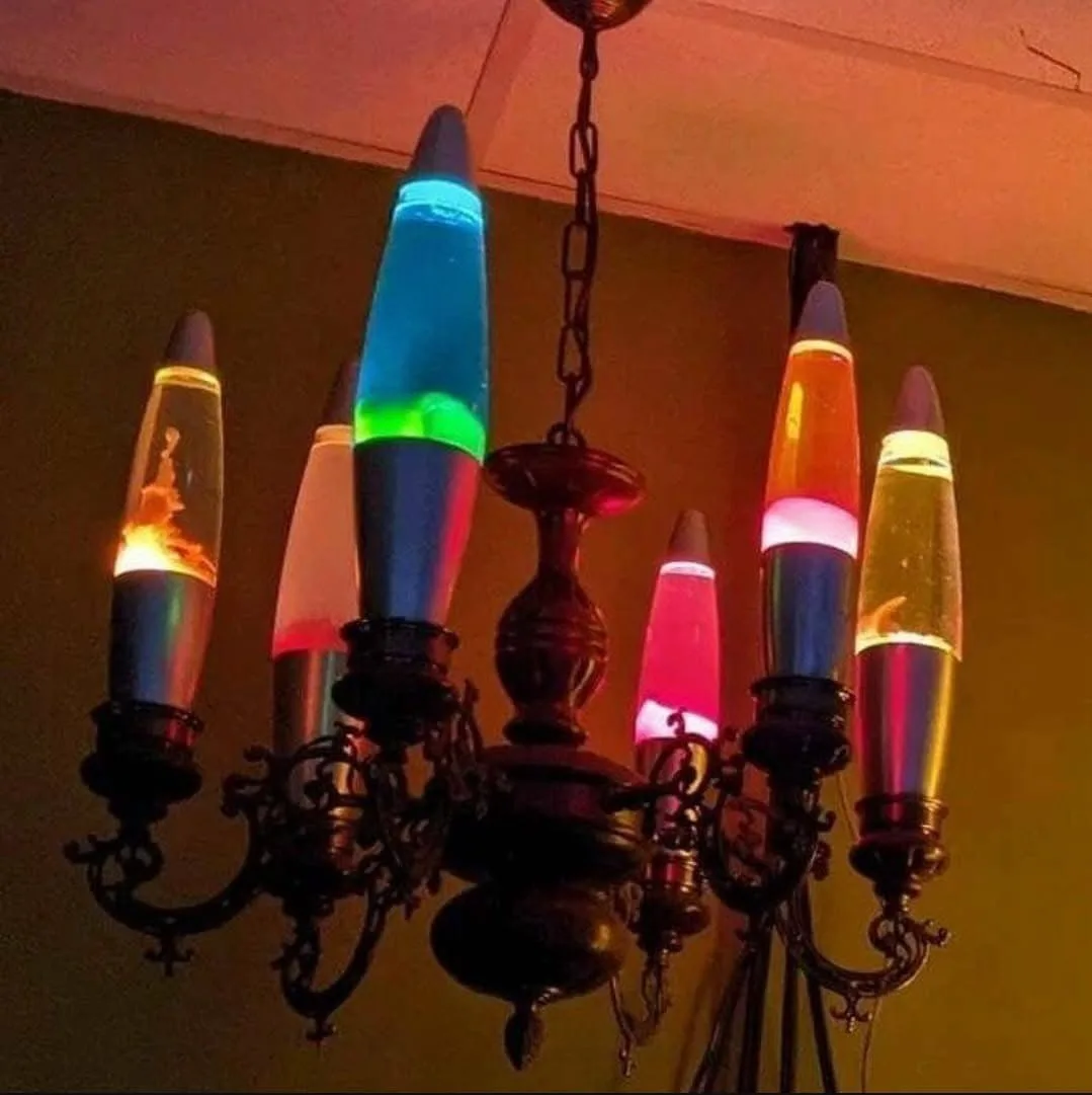 A chandelier with multiple arms, each holding a colorful lava lamp instead of traditional light bulbs, hanging from a…