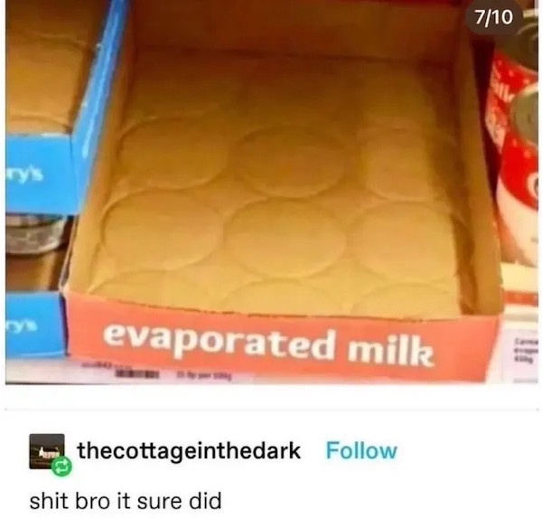 An empty cardboard box labeled 'evaporated milk' sits on a store shelf, its interior showing circular indentations where…