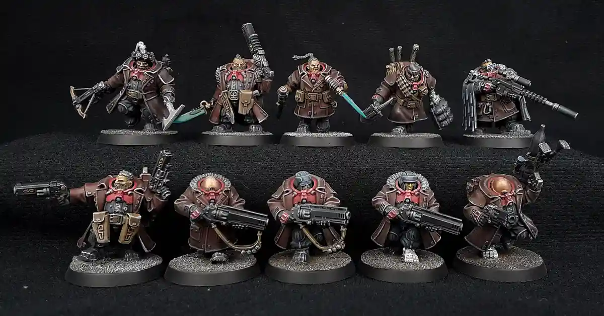 Ten painted miniature figures of heavily armed, grim-faced warriors in brown coats and red armor stand in two rows against a…