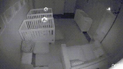 A six-panel security camera sequence shows a baby in a white crib, initially lying down, then rolling over, and finally…