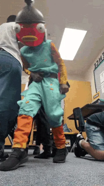 A person in a full-body costume resembling the animated character 'Fish' from 'Phineas and Ferb' is captured in a sequence…