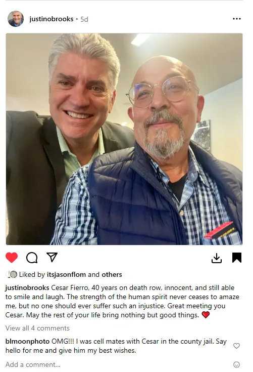 A selfie shows two men smiling at the camera; the man on the left has gray hair and wears a suit, while the man on the right…