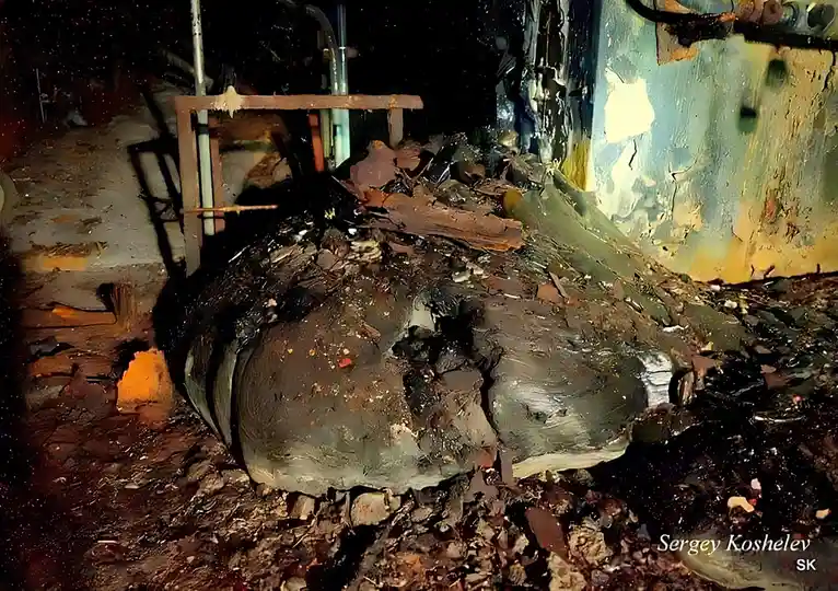 A dark, gritty, and messy industrial or construction site with debris, broken concrete, rusted metal, and peeling paint on…
