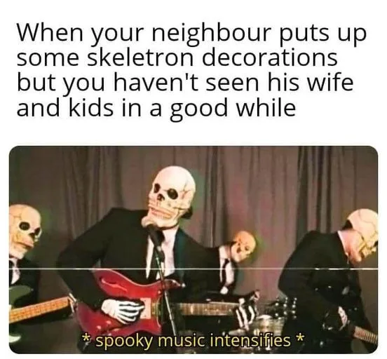 A photo of a band with skeletons dressed in suits playing electric guitars on a stage with a dark curtain backdrop. The…