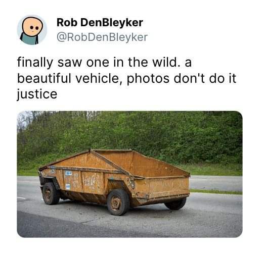A rusty, dilapidated dump truck is shown on a road with trees in the background. Overlaid text reads: 'finally saw one in…