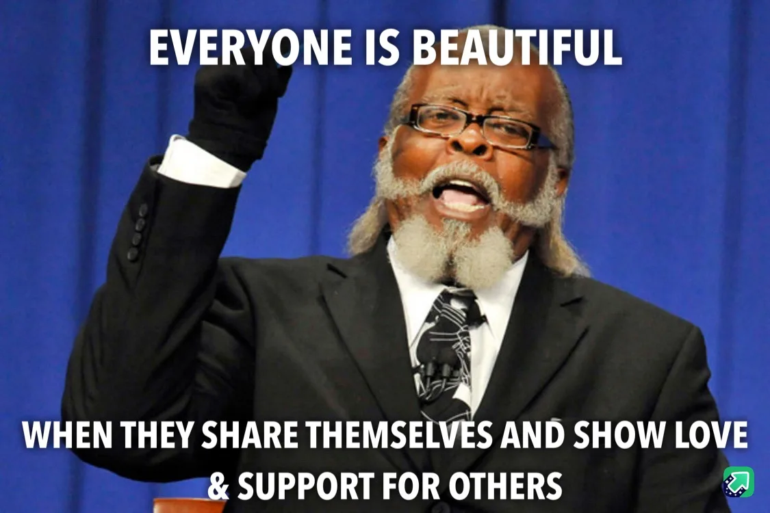 A man in a black suit and glasses, with a white beard and black gloves, raises his right fist while speaking passionately…