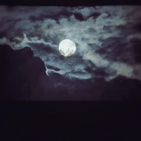 A six-panel grid shows a full moon partially obscured by dark, swirling clouds, with the moon appearing to be eaten or…
