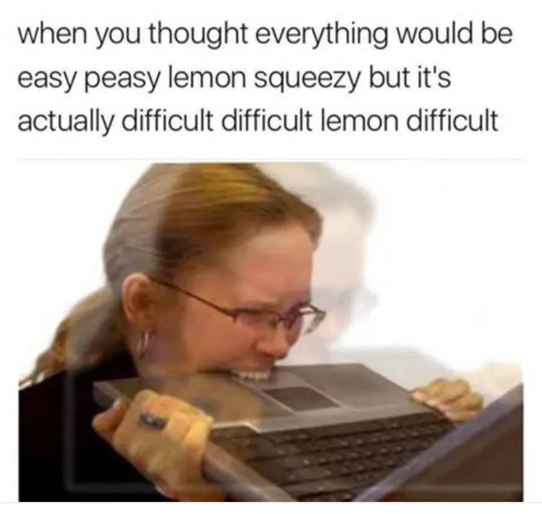 A woman with glasses and her hair in a ponytail is shown biting down on a laptop keyboard with a strained, frustrated…