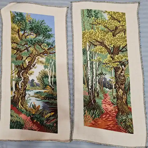 Two side-by-side tapestry panels depicting autumnal forest scenes, one with a river and the other with a path, both…