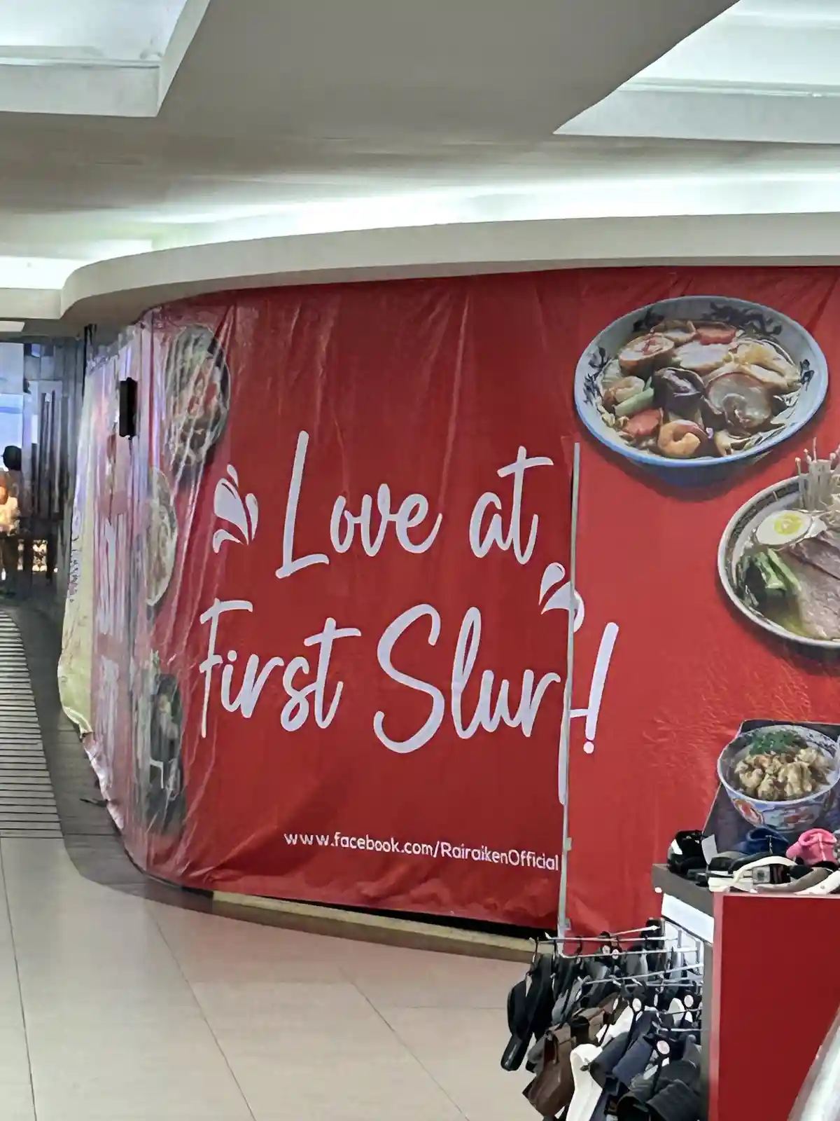 A red promotional banner for a ramen restaurant features images of ramen bowls and the text 'Love at First Slur!' with a…