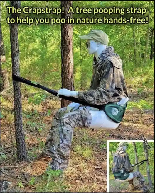 A mannequin dressed in camouflage clothing and a cap is seated outdoors between two trees, holding a black strap that is…