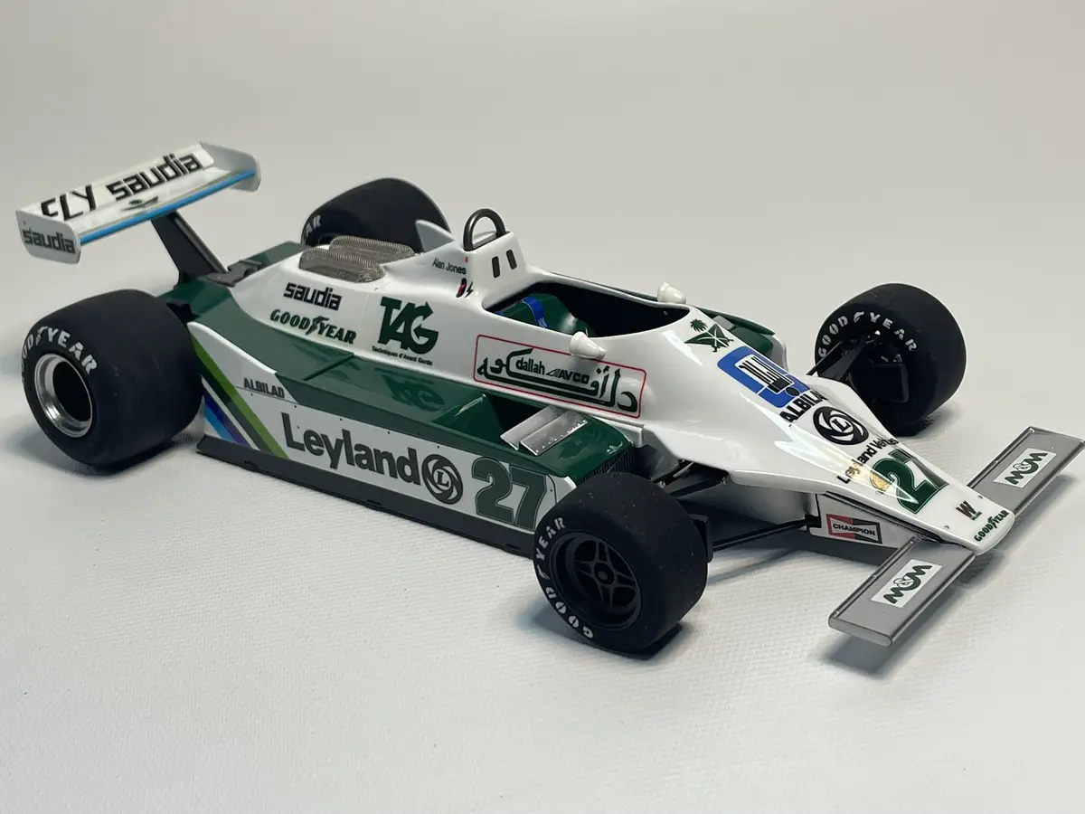 A detailed scale model of a white and green Formula 1 race car, number 27, with sponsor logos like 'Leyland', 'Goodyear'…