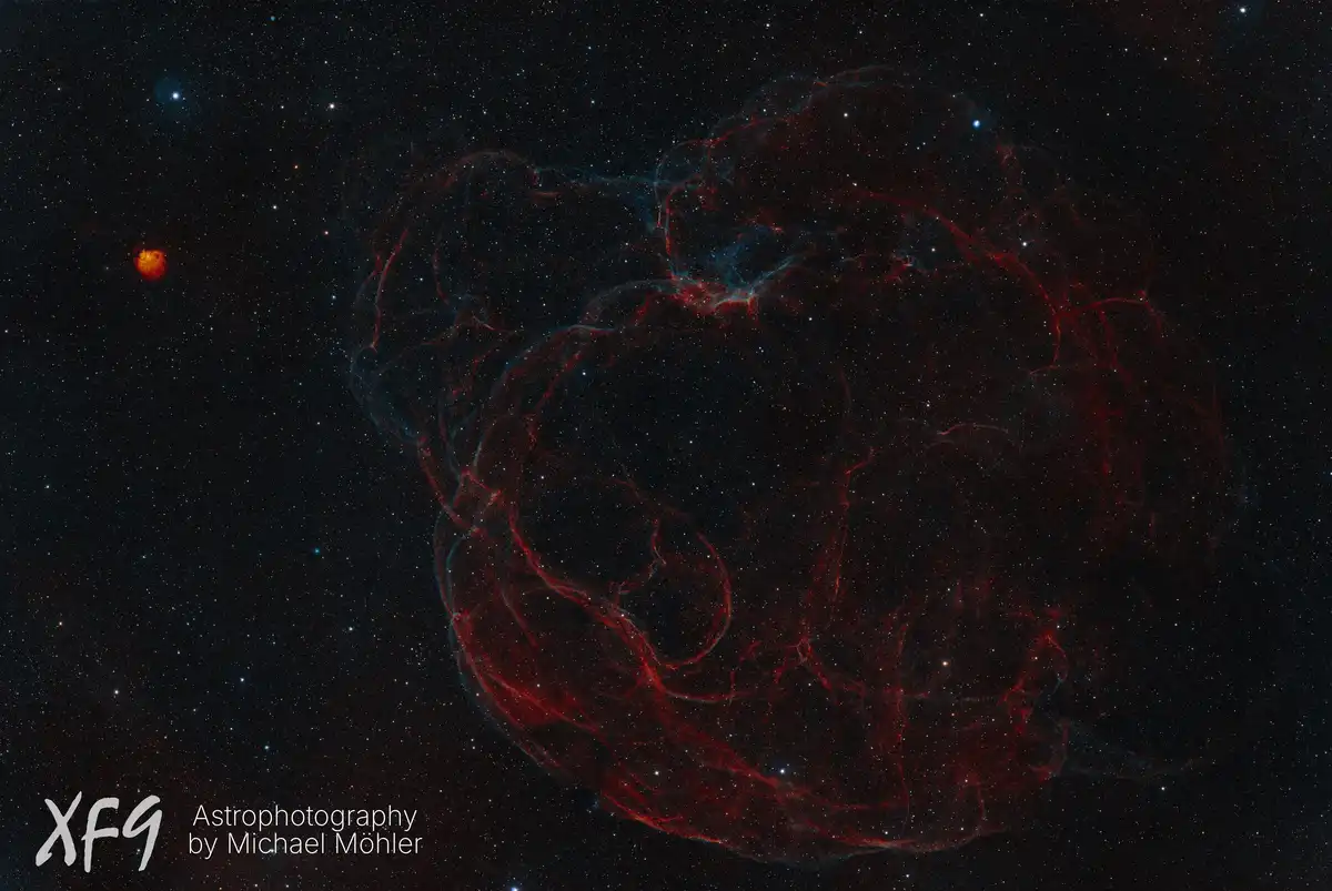 A cosmic nebula with intricate red and blue filaments against a starfield, with overlaid text reading 'XF9 Astrophotography…