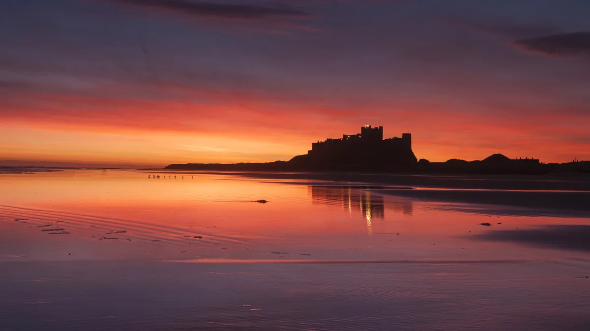 Bamburgh Castle, a 12th-century stronghold, sits proudly on England's northeast coast, where it's been a witness to…