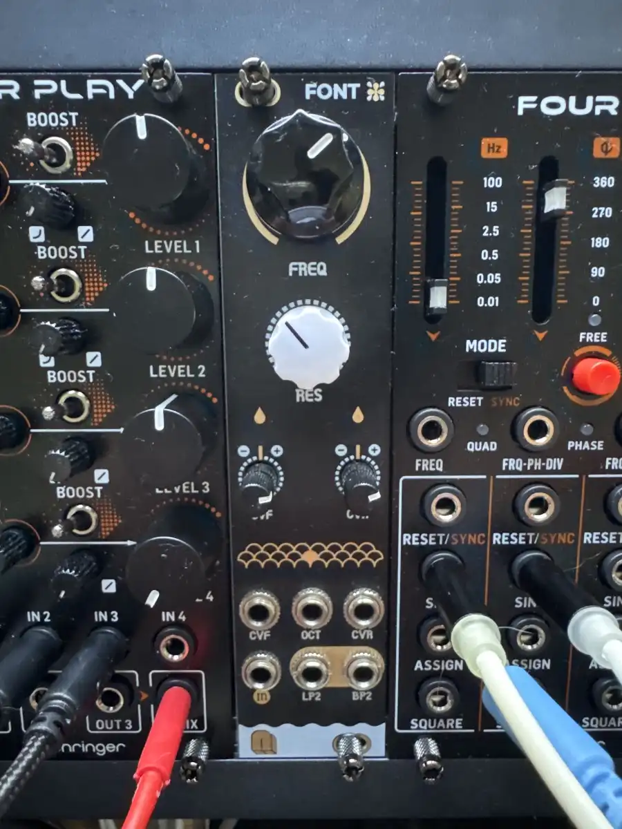 A close-up photo of a black modular synthesizer panel with knobs, sliders, and patch cables. The text overlay reads 'i'm not…