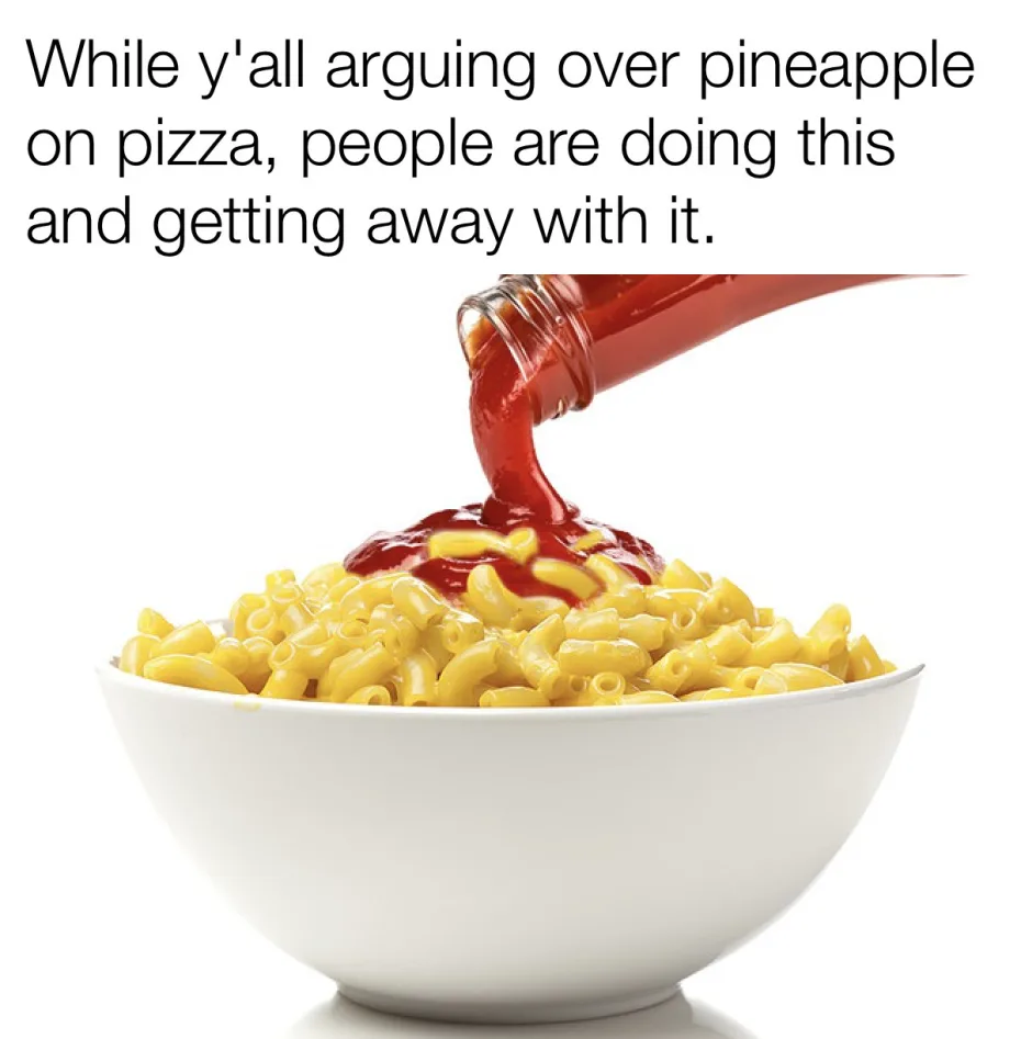 A white bowl filled with cooked elbow macaroni is shown against a plain white background. A glass bottle is pouring red…
