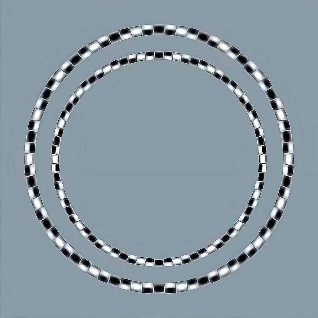Two concentric silver beaded chains form perfect circles against a plain gray background. The overlaid text reads 'i'm not…