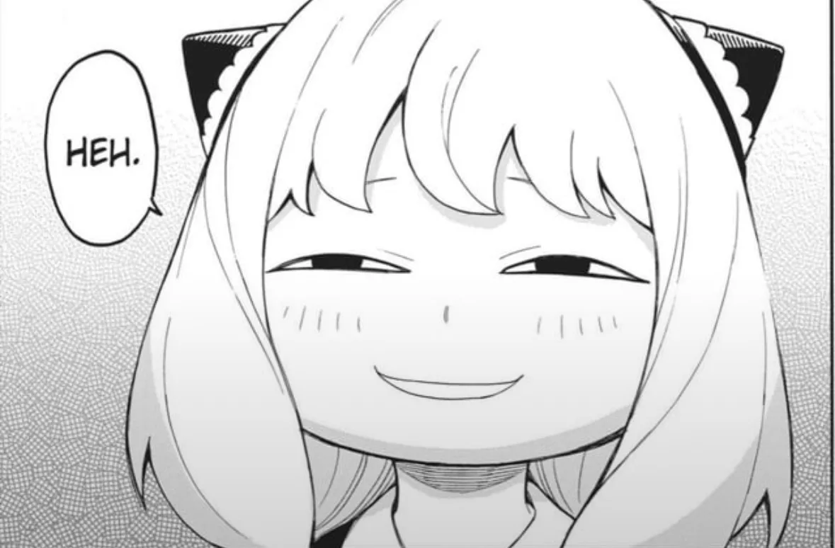 A black-and-white manga panel shows a young anime girl with cat ears and short hair, smiling smugly with narrowed eyes. A…