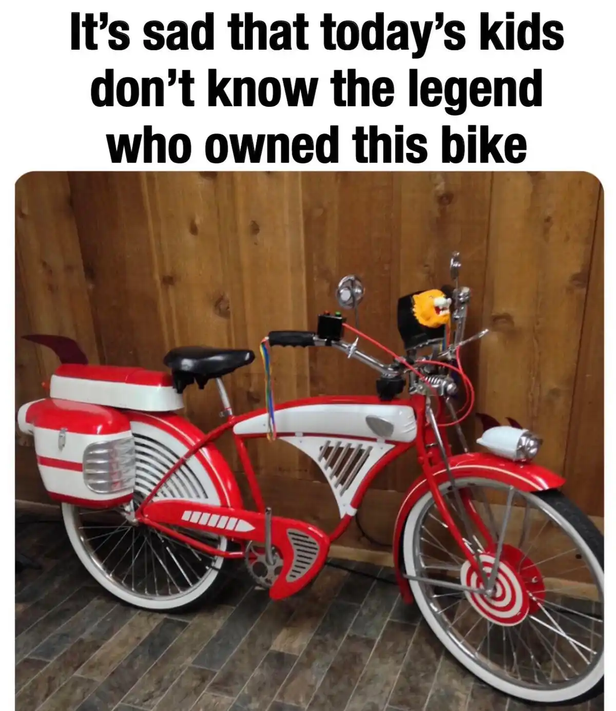 A red and white vintage-style bicycle with exaggerated, futuristic design elements like a lion head on the handlebars, a…