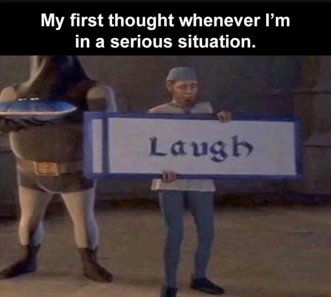 A still from the animated movie 'Shrek' shows a character holding a large sign that reads 'Laugh'. Another character stands…