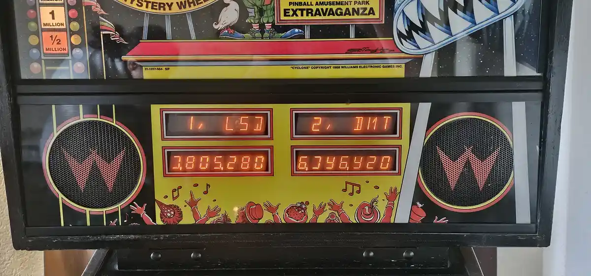A close-up of a Williams 'Cyclone' pinball machine's score display showing two players' scores: Player 1 has 3,805,280 and…