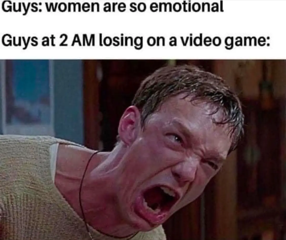 A man with sweaty, disheveled hair and a strained, angry expression, mouth wide open in a scream, wearing a beige sweater…