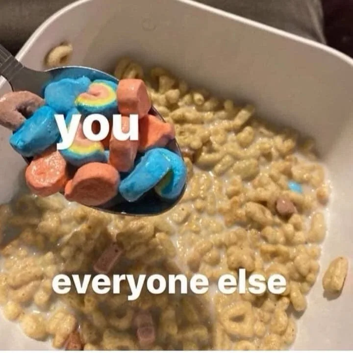 A spoonful of colorful rainbow-shaped cereal pieces is lifted from a bowl of mostly plain, tan-colored cereal with milk. The…