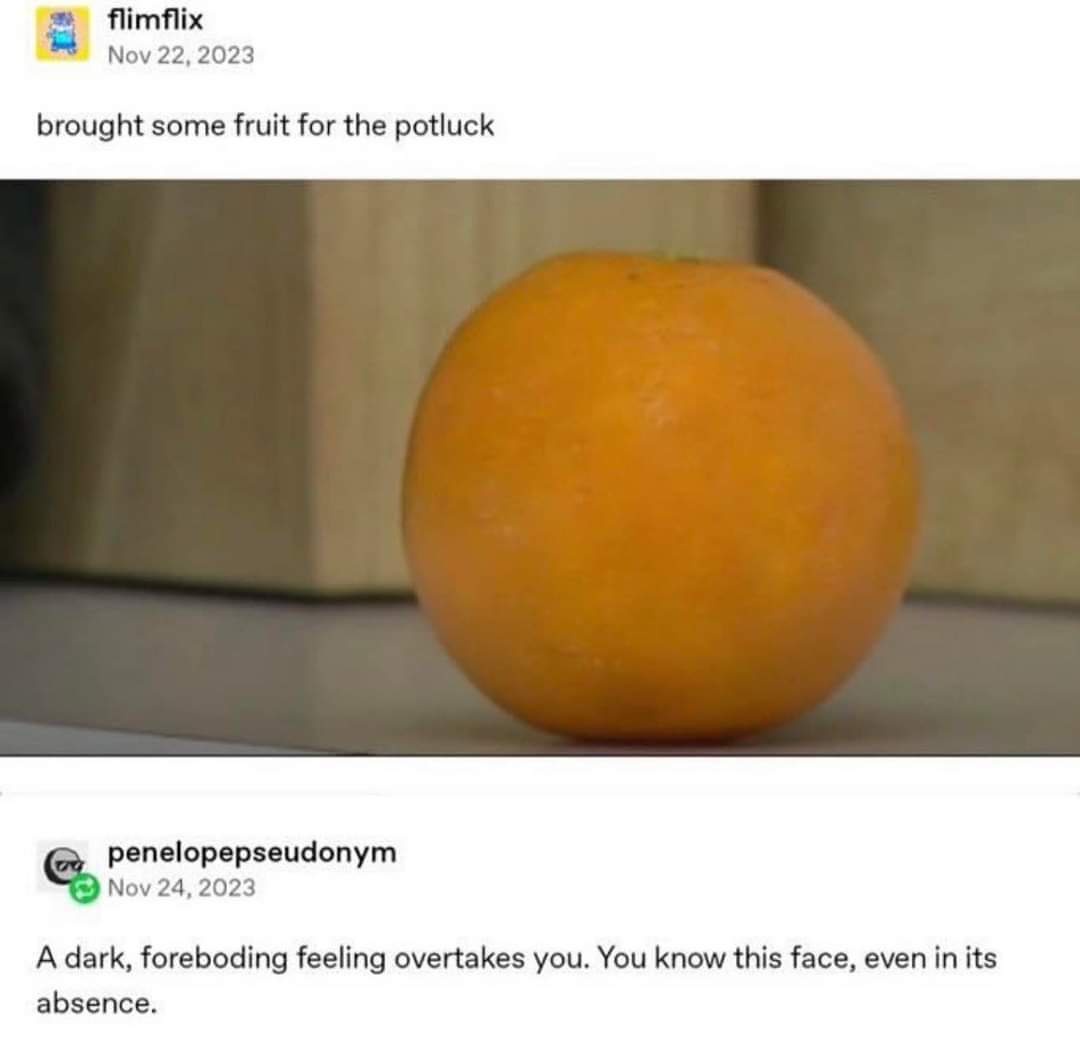 The image shows a close-up of a single, round, orange-colored fruit, likely an orange, sitting on a flat surface. The…