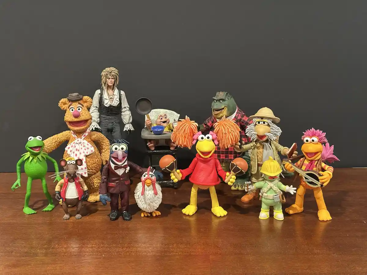 A collection of Muppet character action figures, including Kermit, Fozzie, Gonzo, Miss Piggy, Animal, and others, are…