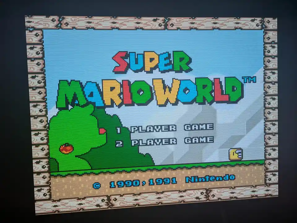 The image displays the title screen of the classic Super Nintendo game 'Super Mario World', featuring its iconic pixelated…