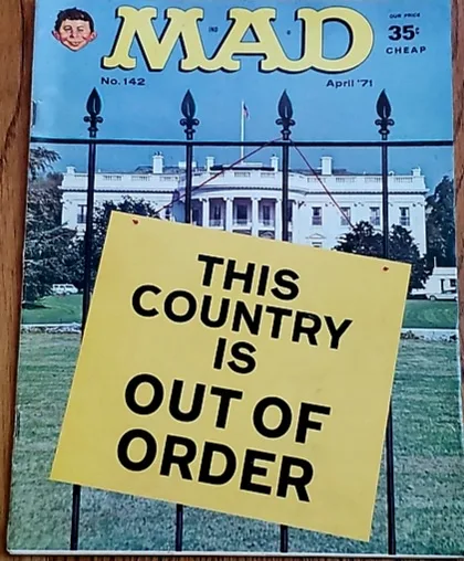 A vintage MAD magazine cover from April 1971, issue #142, shows the White House behind a black wrought-iron fence. A large…