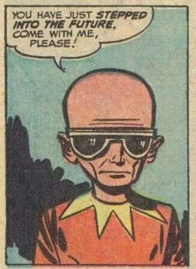 A bald, middle-aged man wearing large, dark sunglasses and an orange shirt with a yellow collar stands against a plain teal…