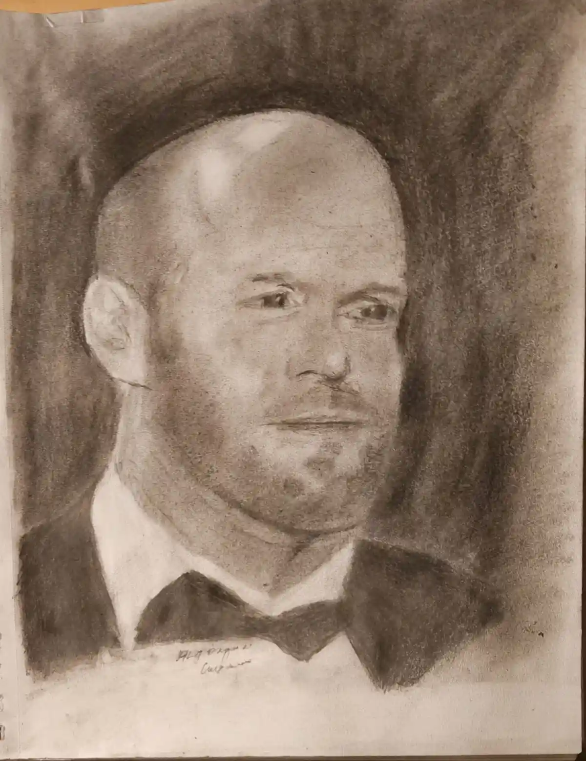A sepia-toned charcoal portrait drawing of a bald man with a serious expression, wearing a white collared shirt and a black…