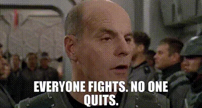 The image displays a repeated still of actor John Candy in a military uniform, looking shocked or alarmed, with the text…