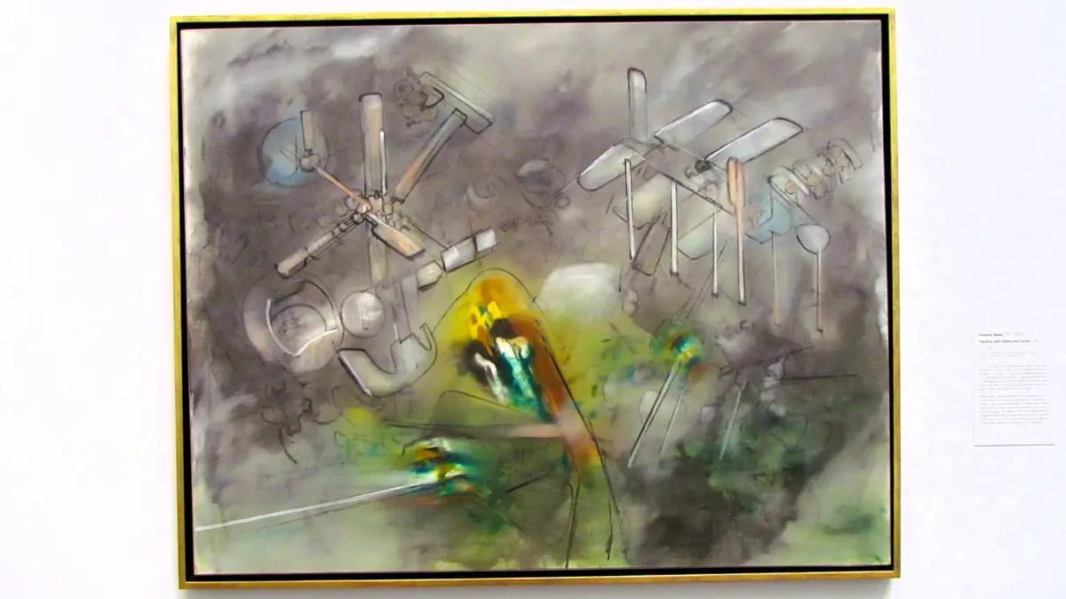 A framed abstract painting by Roberto Matta, titled 'Painting with Yellow and Green,' hangs on a white wall. The artwork…