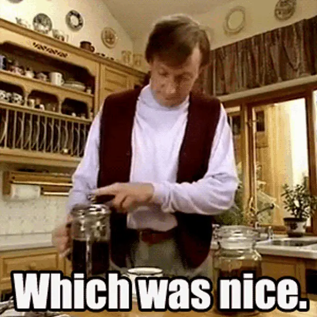 A six-panel grid shows a man in a white turtleneck and maroon vest in a kitchen, repeatedly saying 'Which was nice.' while…