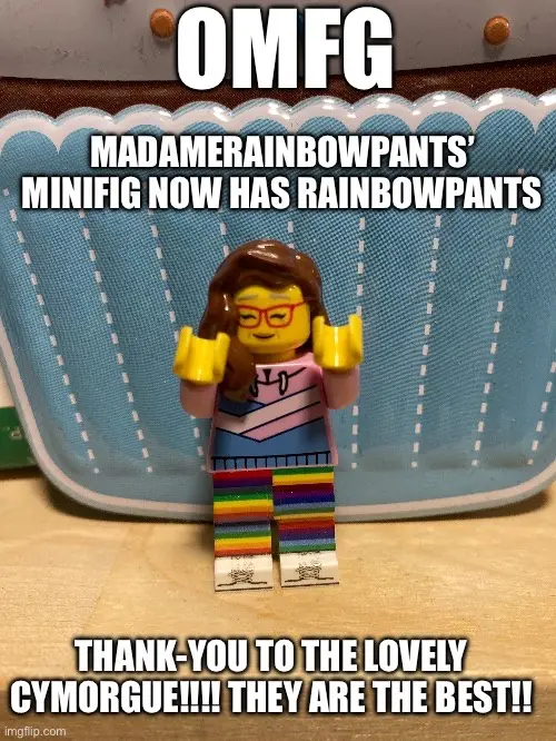 A Lego minifigure with brown hair, red glasses, and a striped shirt stands on rainbow-colored pants, with text overlaid that…