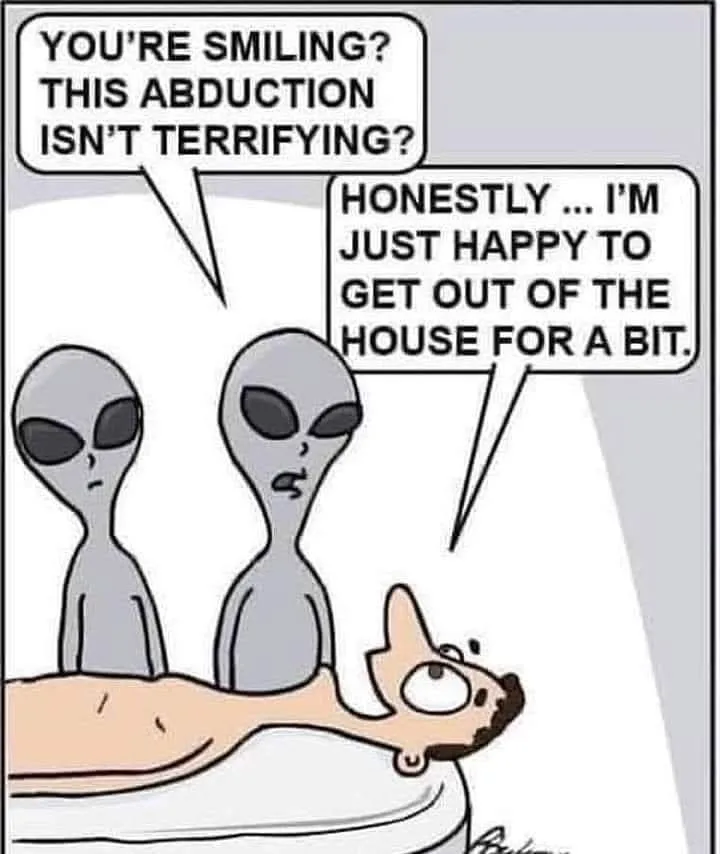 Two gray aliens stand over a human man lying on a table, looking surprised and confused. The alien on the left asks, 'YOU'RE…