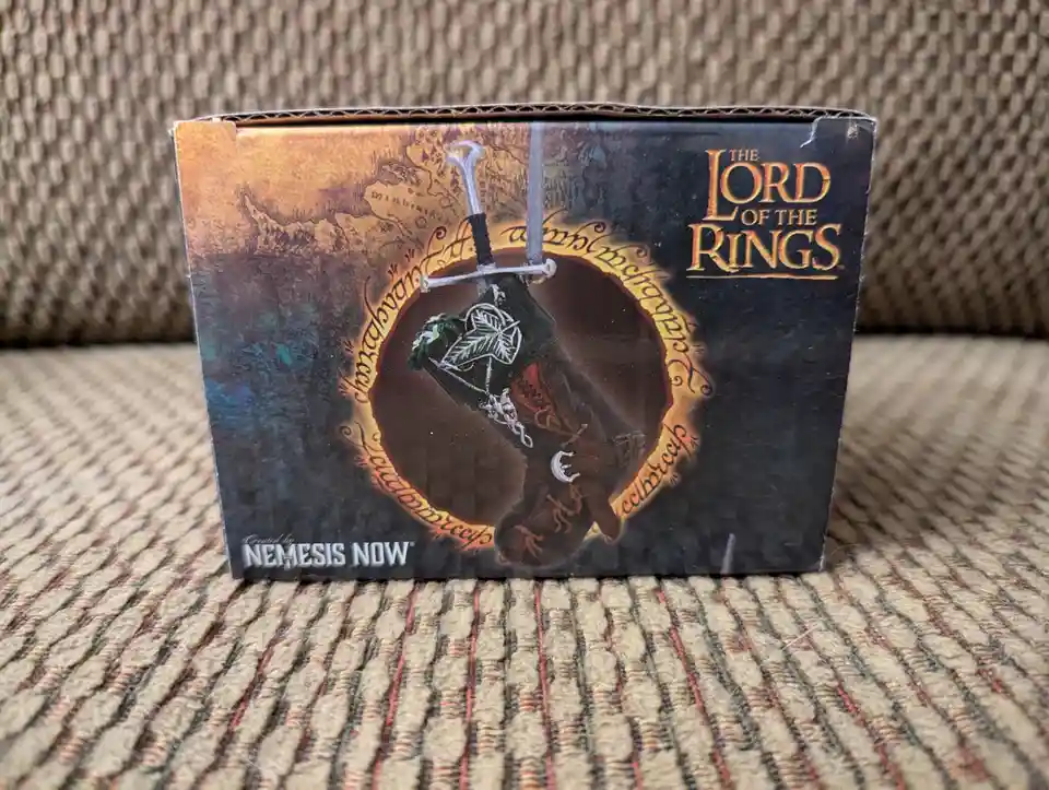 A cardboard box for a 'The Lord of the Rings' themed product, likely a stocking or ornament, featuring a map of…