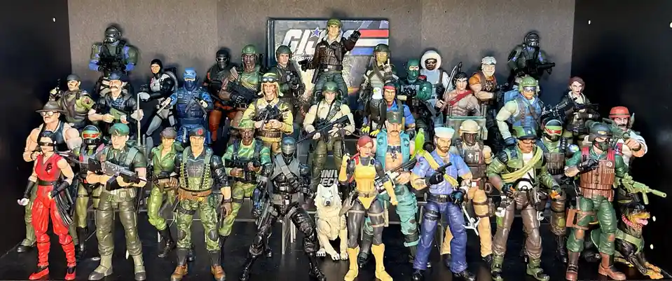 A large group of G.I. Joe action figures, including characters like Duke, Snake Eyes, and Lady Jaye, are posed together in…