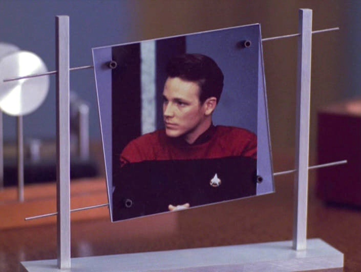 A still image from Star Trek: The Next Generation shows a portrait of Captain Jean-Luc Picard suspended in a futuristic…