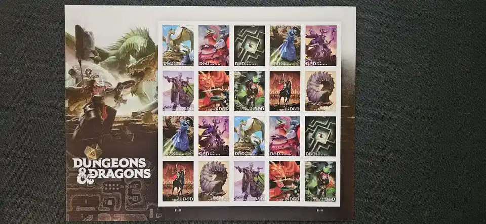 A sheet of 20 Dungeons & Dragons themed U.S. postage stamps featuring various fantasy characters and dragons, displayed next…