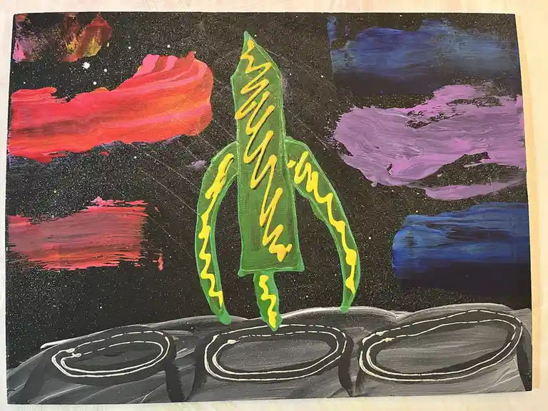 A hand-painted artwork depicts a green banana with yellow squiggly lines resembling flames, standing upright on a gray…