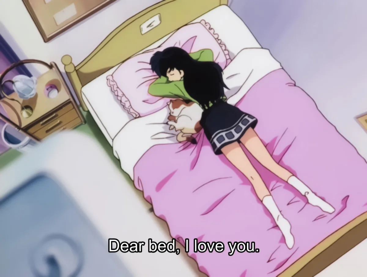 An anime girl with black hair sleeps in a bed with pink sheets, hugging a cat, while text at the bottom reads 'Dear bed, I…
