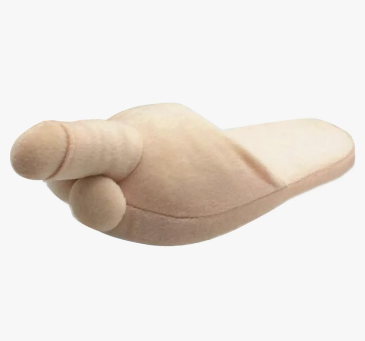 a beige plush slipper shaped like a human foot with toes pointing forward, set against a plain white background. The…