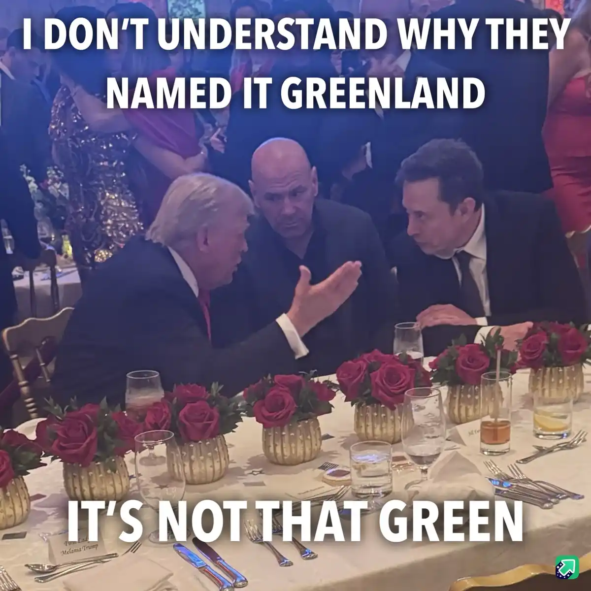 Three men sit at a formal dinner table with red roses and silverware; the man on the left gestures while speaking to the man…
