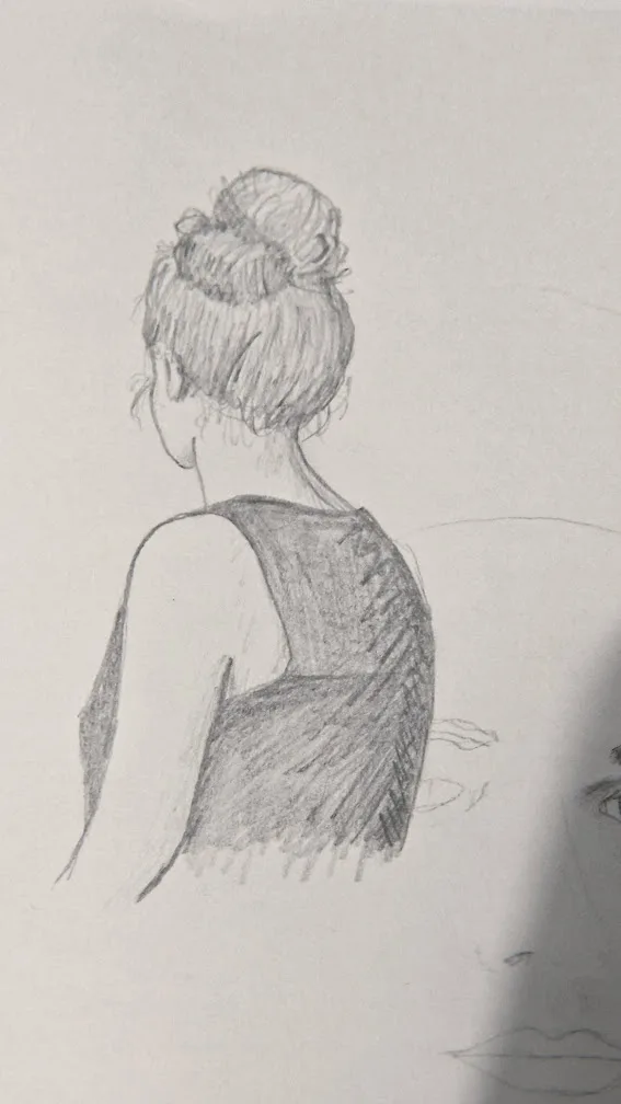 A pencil sketch shows the back of a person with hair in a bun, wearing a sleeveless top, while a partially drawn face is…