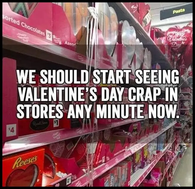 A photo of a supermarket aisle filled with Valentine's Day merchandise, including heart-shaped boxes of chocolates and…