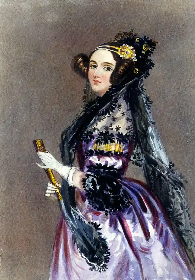 A vintage portrait of a woman in 19th-century attire, wearing a purple and white dress with black lace trim and a decorative…